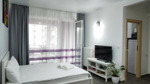 a bedroom with a white bed and a window at BELLE VIEW SINAIA-free parking in Sinaia