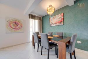 a dining room with a table and chairs at Stunning 2BR home with spacious living in Ta'Xbiex by 360 Estates in Taʼ Xbiex