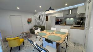 a kitchen and dining room with a table and chairs at Inaya Home for you appt 3 Pièces Menton in Menton
