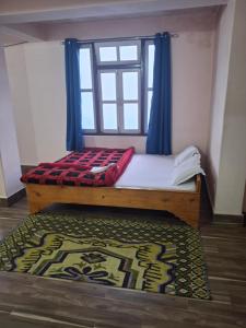 Hotel Rainbow Regency Ravangla South Sikkim客房内的一张或多张床位