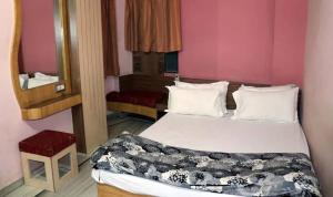 a bedroom with a large bed and a mirror at Family Fun DELUXE VILLA 1 in Talguppa