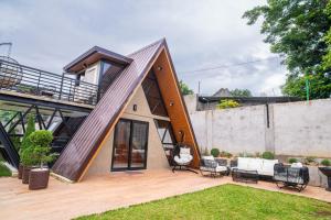 a house with a large deck and a patio at A Skylight Cabin in Santo Tomas