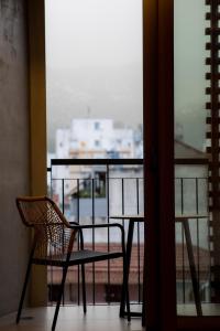 a chair and a table in front of a window at Magnes Hotel in Volos