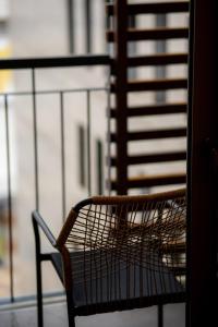 a bench sitting on top of a balcony at Magnes Hotel in Volos