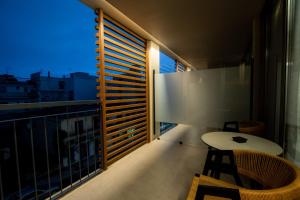 a balcony with a table and chairs and a view at Magnes Hotel in Volos