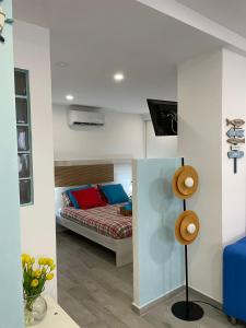 a bedroom with a bed with red and blue pillows at El rincon de Mauro in Altea