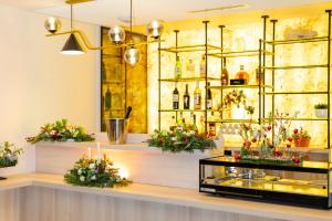 a display case in a store with flowers and wine bottles at GREEN PARK HOTEL PARIS in Paris
