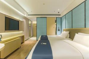 Voodi või voodid majutusasutuse Echarm Hotel Hezhou Avenue toas