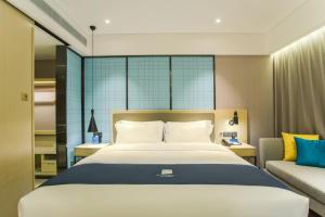 Voodi või voodid majutusasutuse Echarm Hotel Hezhou Avenue toas