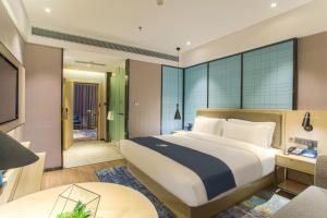 Voodi või voodid majutusasutuse Echarm Hotel Hezhou Avenue toas