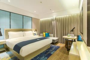 Voodi või voodid majutusasutuse Echarm Hotel Hezhou Avenue toas