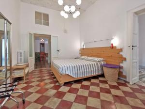 a bedroom with a bed and a checkered floor at L'Officina in Bari +74 photos