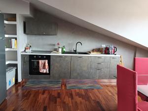 a kitchen with a sink and a stove at Mansarda Open Space in Ciampino