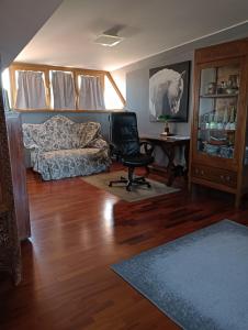 a living room with a couch and a chair at Mansarda Open Space in Ciampino