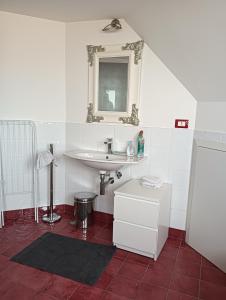 a bathroom with a sink and a mirror at Mansarda Open Space in Ciampino