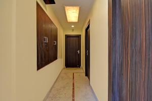 a hallway with two doors and a corridorngthngthngthngthngthngthngthngth at Collection O Ketan Regency Near Acropolis Mall in Kolkata