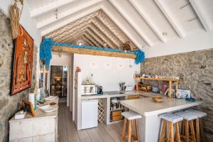 a kitchen with a table and chairs in a room at Casa Neverland in Vila Baleira