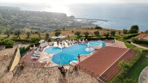 an overhead view of a swimming pool with the ocean at Marasusa Dreams in Parghelia
