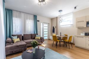 a living room with a couch and a table at Nemes Apartment The Great - Petite in Nemesvita
