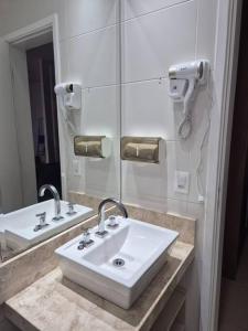 a bathroom with a white sink and a mirror at Loft, seu espaço com conforto in Mogi das Cruzes +30 photos