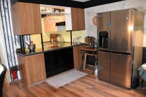 a kitchen with a stainless steel refrigerator and a counter at Urbanes Lebensgefühl in Basel in Basel