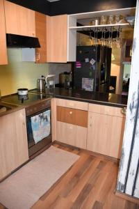 a kitchen with black counter tops and wooden cabinets at Urbanes Lebensgefühl in Basel in Basel +3 photos