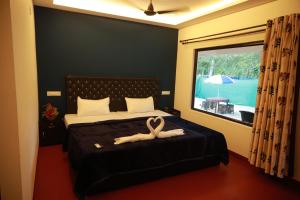 a bedroom with a bed with two towels on it at Kadal beach house marari in Mararikulam
