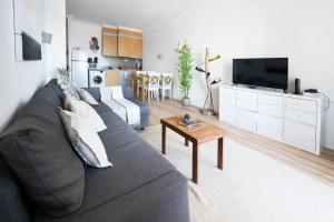 a living room with a couch and a table at Ribeira DIlhas Beach Apartment in Ericeira
