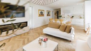 a living room with a white couch and a fireplace at Casa Lei by Villas Holiday in Malinska
