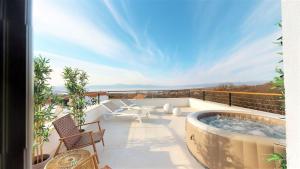 a patio with a hot tub on a balcony at Casa Lei by Villas Holiday in Malinska