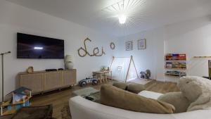 a living room with a couch and a flat screen tv at Casa Lei by Villas Holiday in Malinska