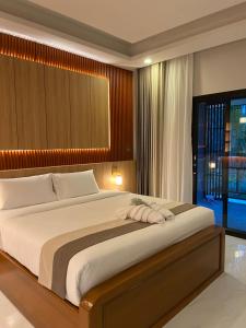 a bedroom with a large bed in a room at The Cushty Days Lanta in Ko Lanta +53 photos
