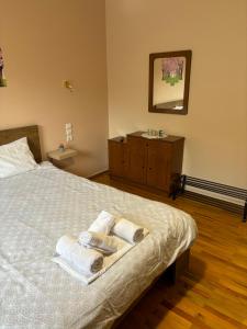 a bedroom with a bed with towels and a sink at Paradise of Meteora B in Kastrákion