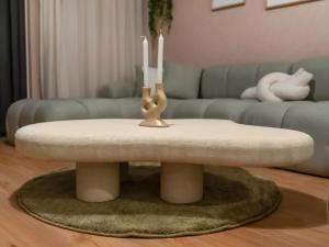 a living room with a table with two candles on it at Wabi-Sabi Style Fountain-View 4 BR Apt in the Sky in Dubai