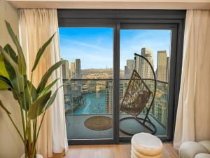 a room with a large window with a view of the city at Wabi-Sabi Style Fountain-View 4 BR Apt in the Sky in Dubai