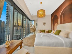 a bedroom with a large bed and a large window at Wabi-Sabi Style Fountain-View 4 BR Apt in the Sky in Dubai