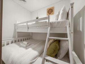 a bunk bed room with two bunk beds at Wabi-Sabi Style Fountain-View 4 BR Apt in the Sky in Dubai