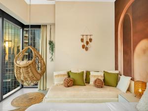 a living room with a couch and a large window at Wabi-Sabi Style Fountain-View 4 BR Apt in the Sky in Dubai