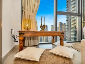 a room with a table and a large window at Wabi-Sabi Style Fountain-View 4 BR Apt in the Sky in Dubai
