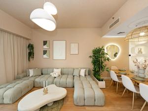 a living room with a couch and a table at Wabi-Sabi Style Fountain-View 4 BR Apt in the Sky in Dubai