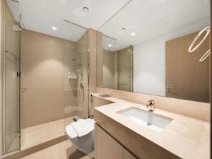 a bathroom with a sink and a toilet and a shower at Wabi-Sabi Style Fountain-View 4 BR Apt in the Sky in Dubai
