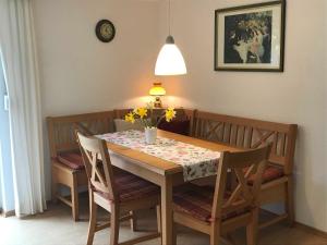 グリュックスブルクにあるFerienwohnung Valentinのダイニングルーム(花のテーブル、椅子付)