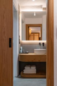 a bathroom with a sink and a mirror at Skepi Town Houses in Mikonos