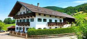 a large white house with a brown roof at Bauernhof Gorihof in Aschau im Chiemgau