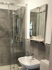 a bathroom with a shower and a sink and a mirror at Bauernhof Gorihof in Aschau im Chiemgau