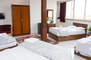 Postel nebo postele na pokoji v ubytování NEW ASSER HOTEL PYRAMID