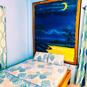 a bedroom with a bed with a painting on the wall at Chef Panyang Beach Resort Okoy in Ocoy +32 photos