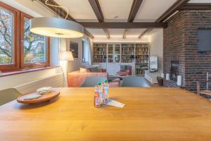 a large wooden table in a living room with a fireplace at Dat Reethuus in Böhl