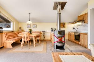a kitchen and dining room with a table and a stove at Bergjuwel Tschengla in Bürserberg
