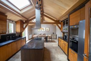 a large kitchen with wooden cabinets and a kitchen island at Domaine Chapelle in La Chapelle-la-Reine